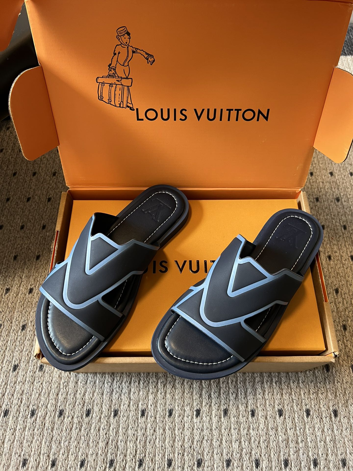 Louis Vuitton slide sandals, black with light blue V-pattern straps, open toe