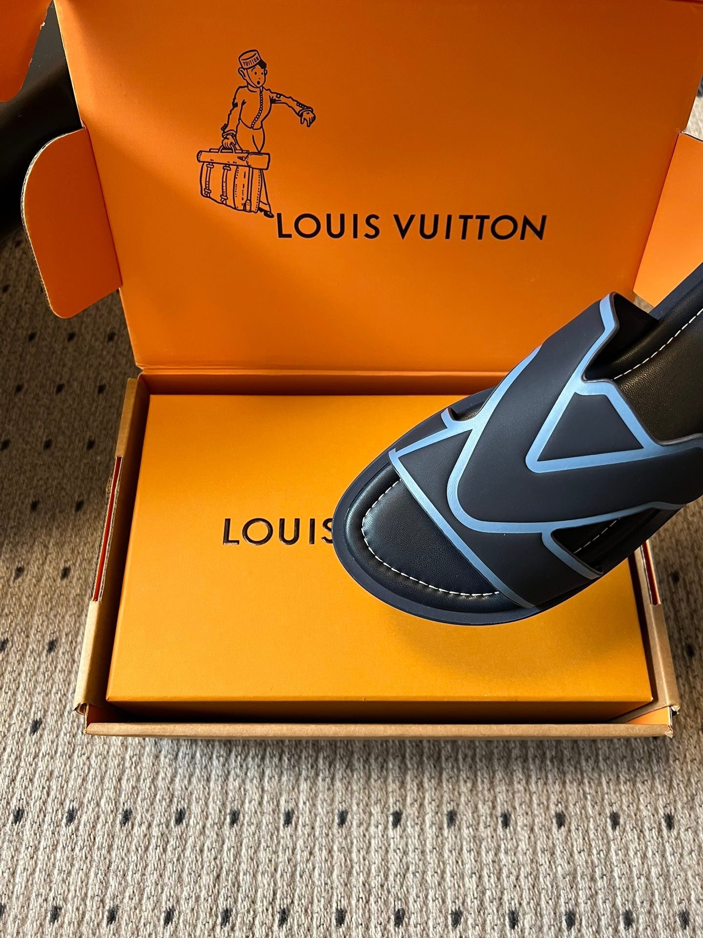 Louis Vuitton slide sandal, black upper with light blue V logo detail