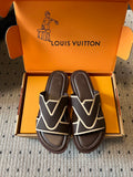 Dark sandals with white V strap design and padded footbed