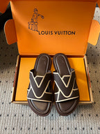 Dark sandals with white V strap design and padded footbed