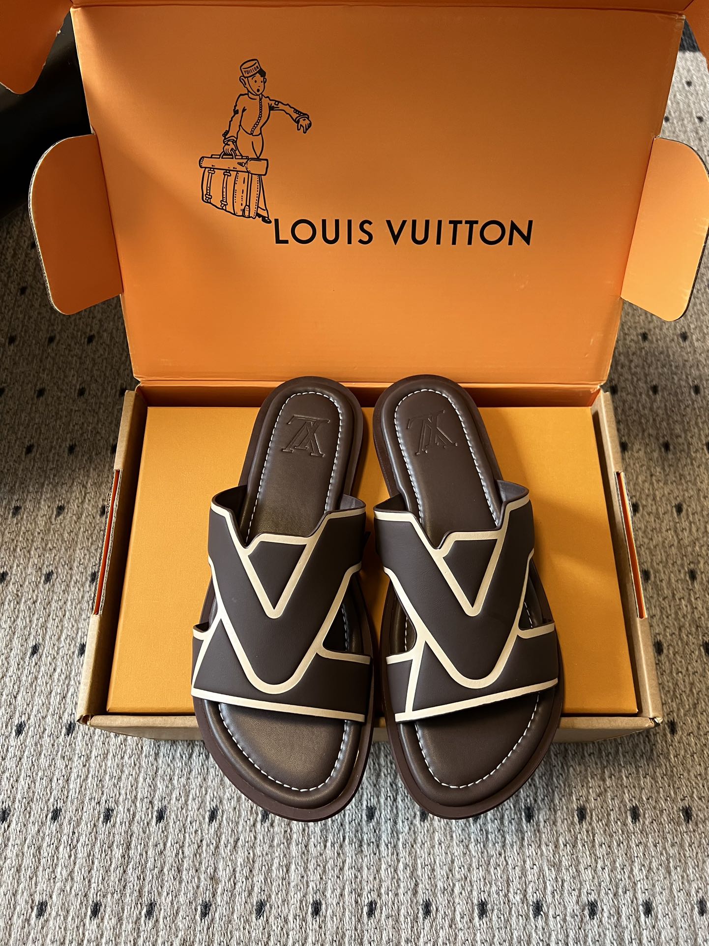 Dark sandals with white V strap design and padded footbed