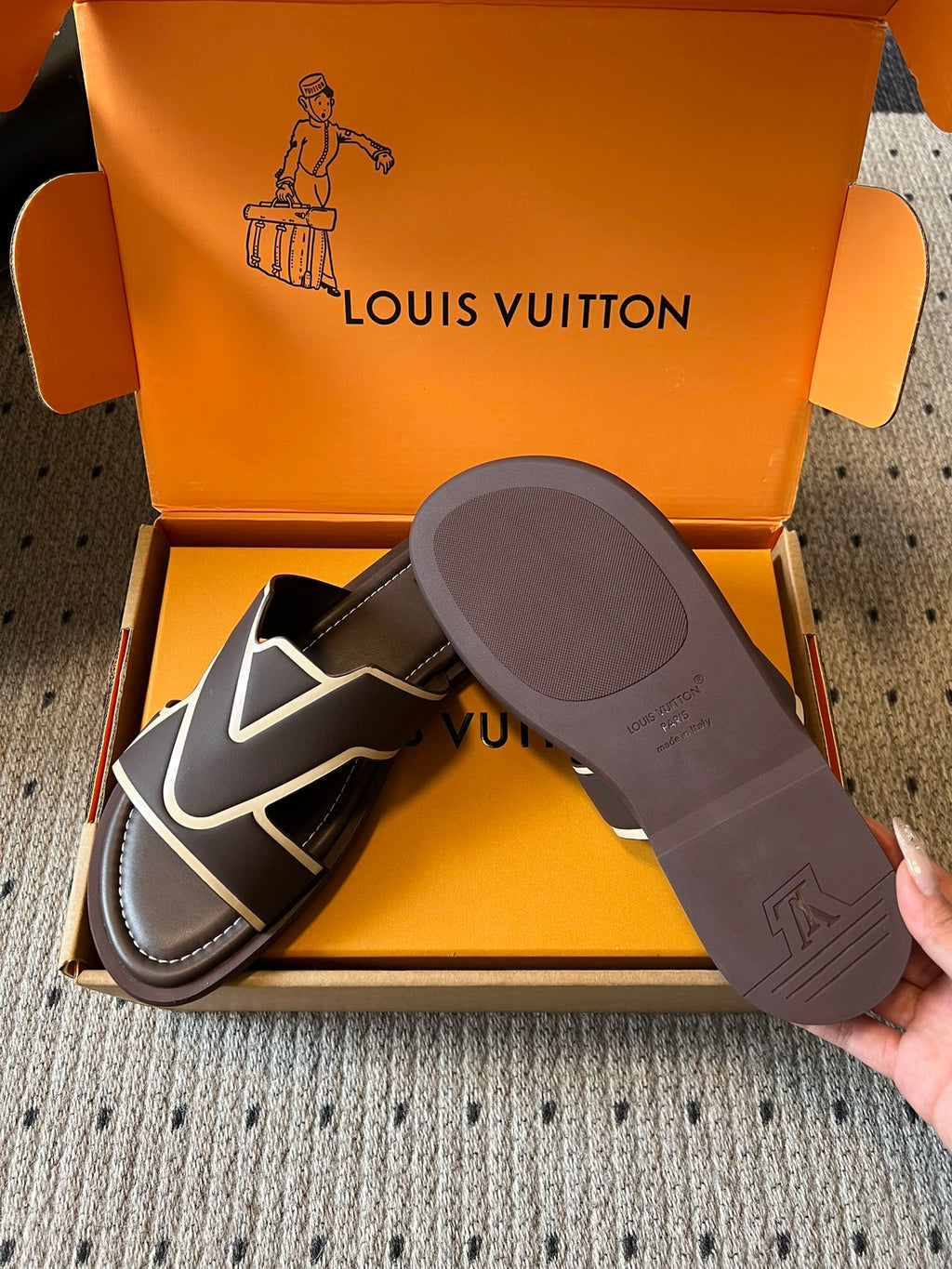 Dark slide sandals with white V strap, shown with gray outsole