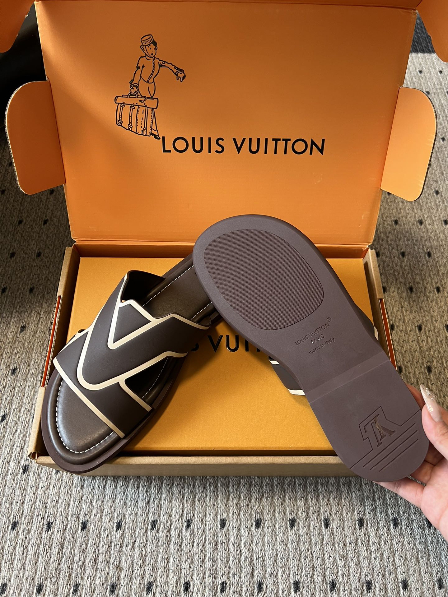 Dark slide sandals with white V strap, shown with gray outsole