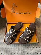 Pair of dark slide sandals with white V motif straps