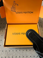 Louis Vuitton sandal with black footbed and black strap in open box, side view