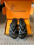 Louis Vuitton sandals in open box, black straps with light blue V detail and cushioned soles