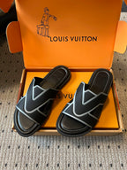 Louis Vuitton slide sandals, black upper with light blue V-shaped logo on straps, in box