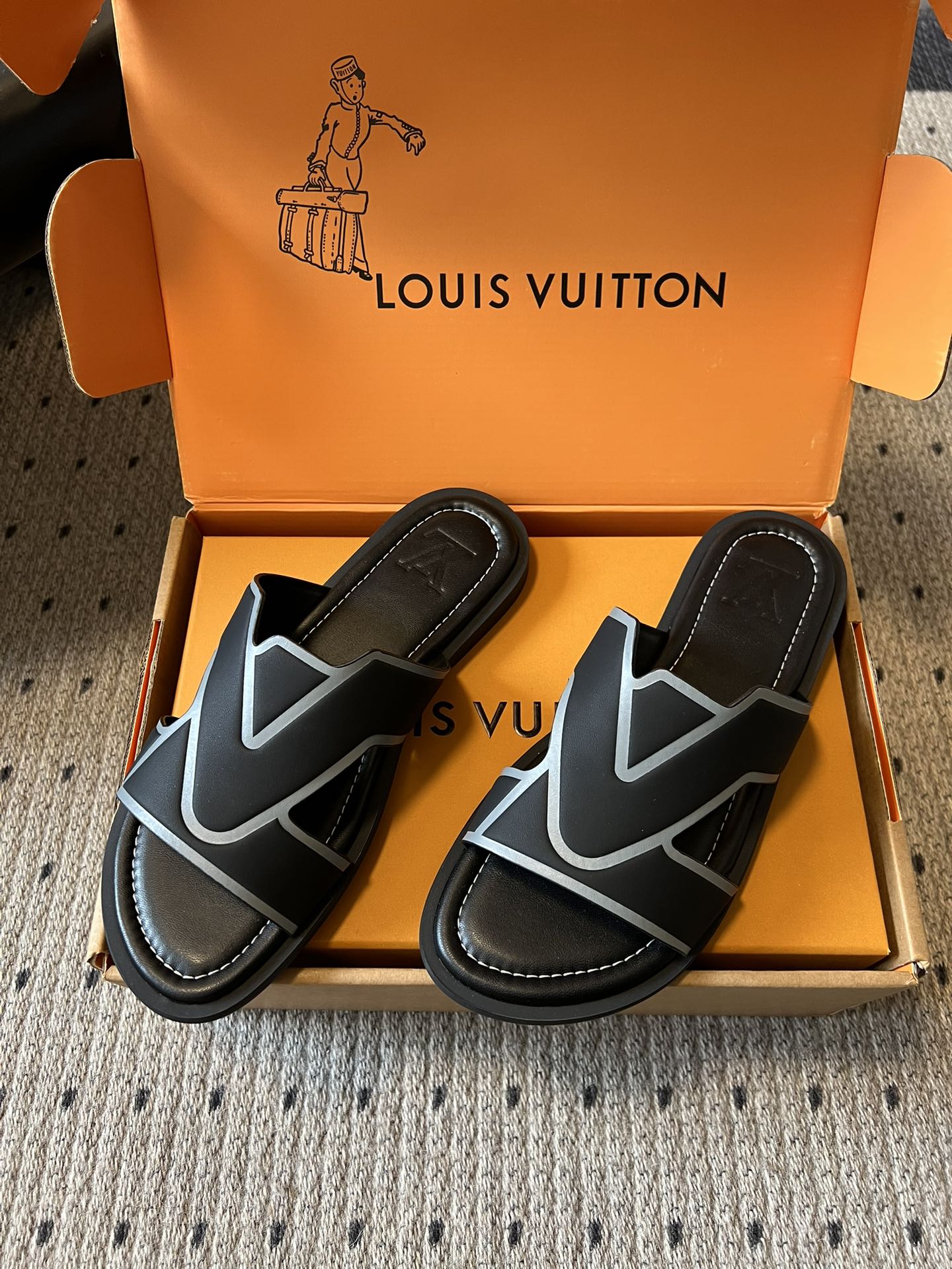 Louis Vuitton slide sandals, black upper with light blue V-shaped logo on straps, in box