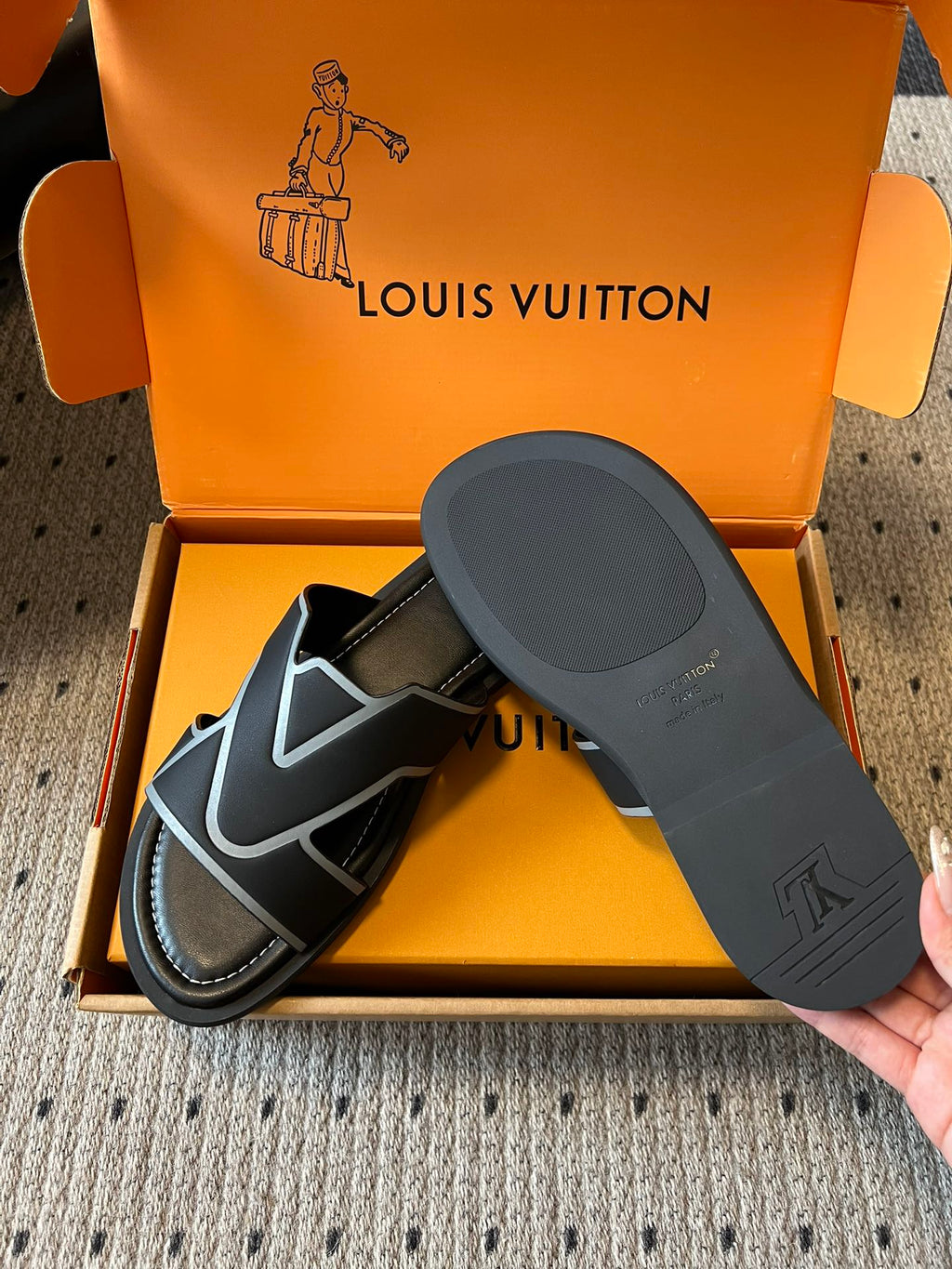 Louis Vuitton sandals in open box with black footbed, black-and-light blue V strap details