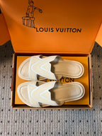 Cream slide sandals showing tan outsole and V strap, in box, Louis Vuitton