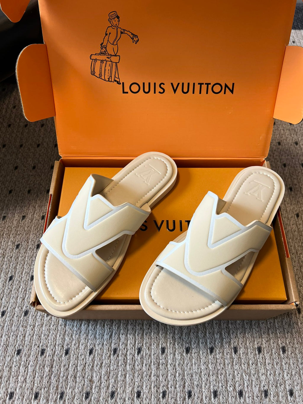 Pair of cream slide sandals with V strap detail and padded lining, Louis Vuitton