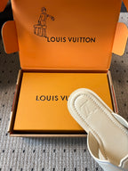 Cream slide sandal with stitched outsole detailing, partially in box, Louis Vuitton