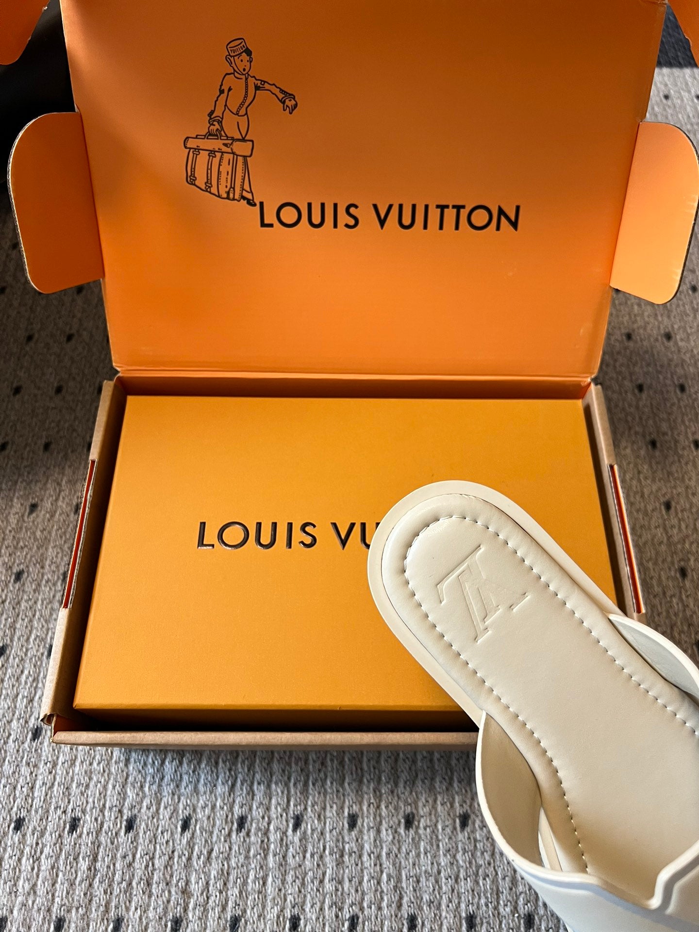 Cream slide sandal with stitched outsole detailing, partially in box, Louis Vuitton