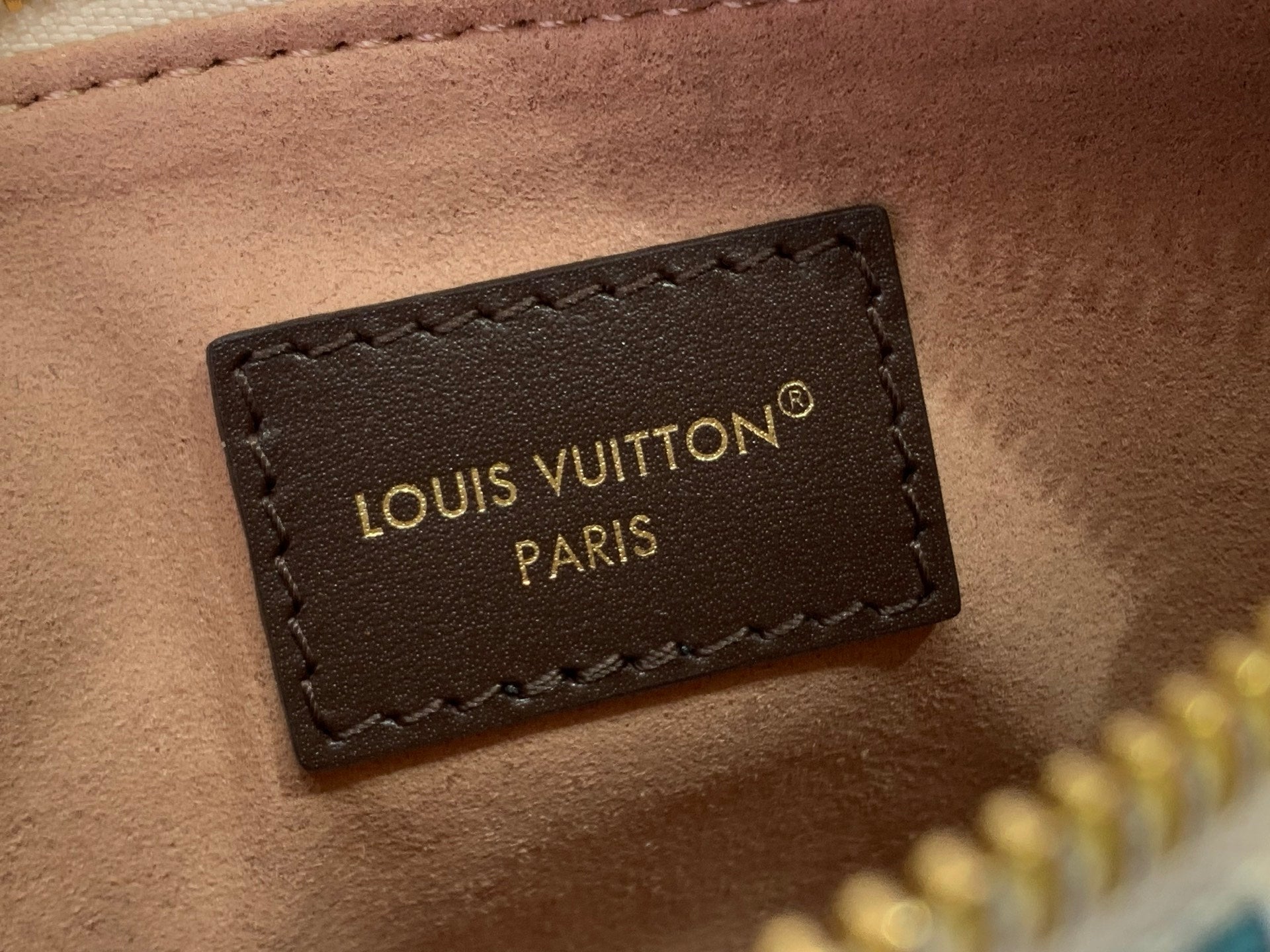Louis Vuitton Paris logo leather label on brown trim