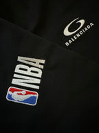 Black shorts close-up of NBA logo patch and Balenciaga logo patch.