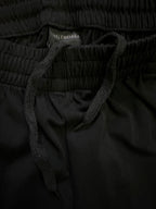 Black shorts close-up showing elastic waistband and dark drawstring.