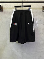 Black shorts with elastic waistband and NBA graphic print on the left leg.