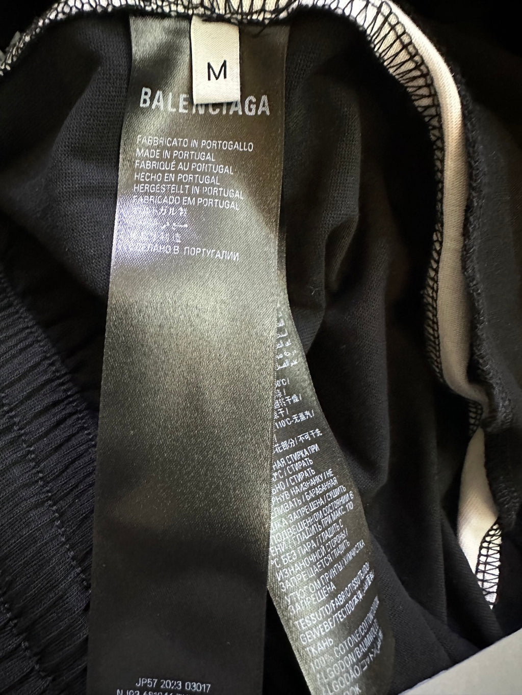 Black shorts inner size label showing “M” and Balenciaga branding.