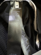 Black shorts inner size label showing “M” and Balenciaga branding.