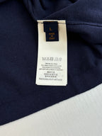 Navy polo shirt with attached white size and care label