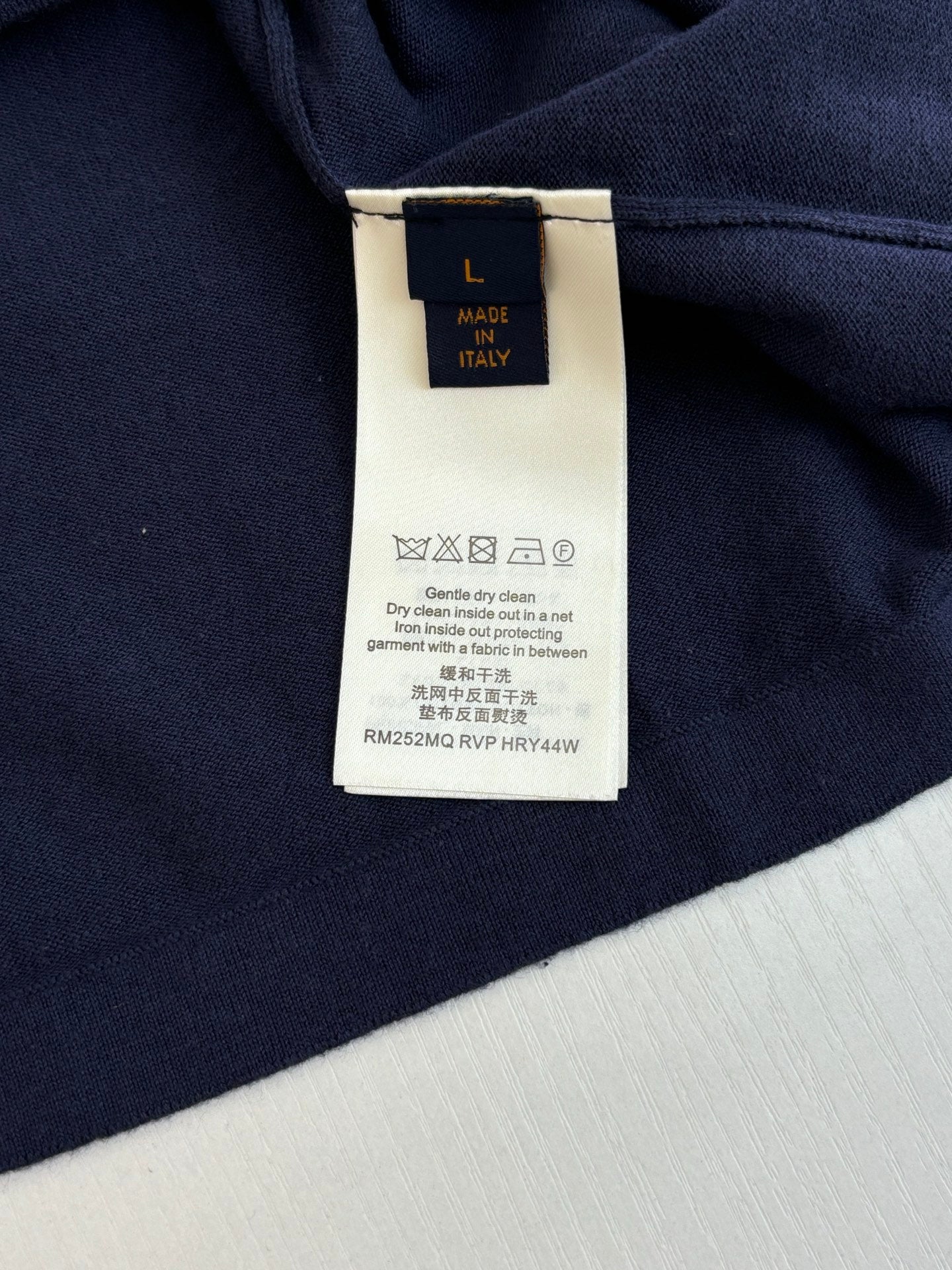 Navy polo shirt with attached white size and care label