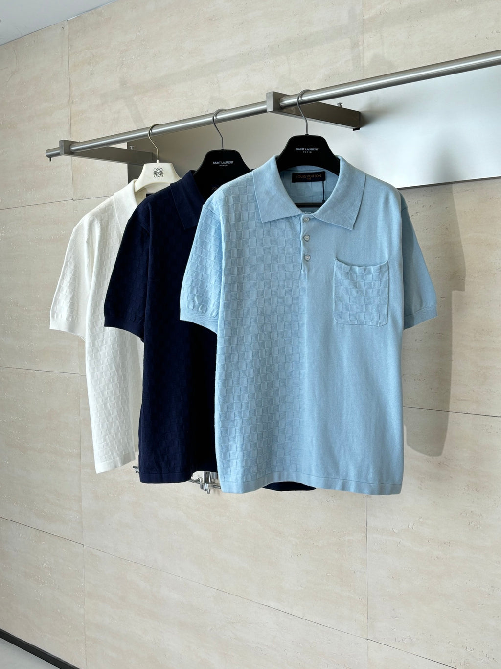 Light blue polo shirt with collar and chest pocket, shown on a hanger