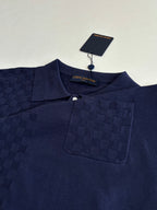 Navy polo shirt close-up with button placket, collar, and chest pocket