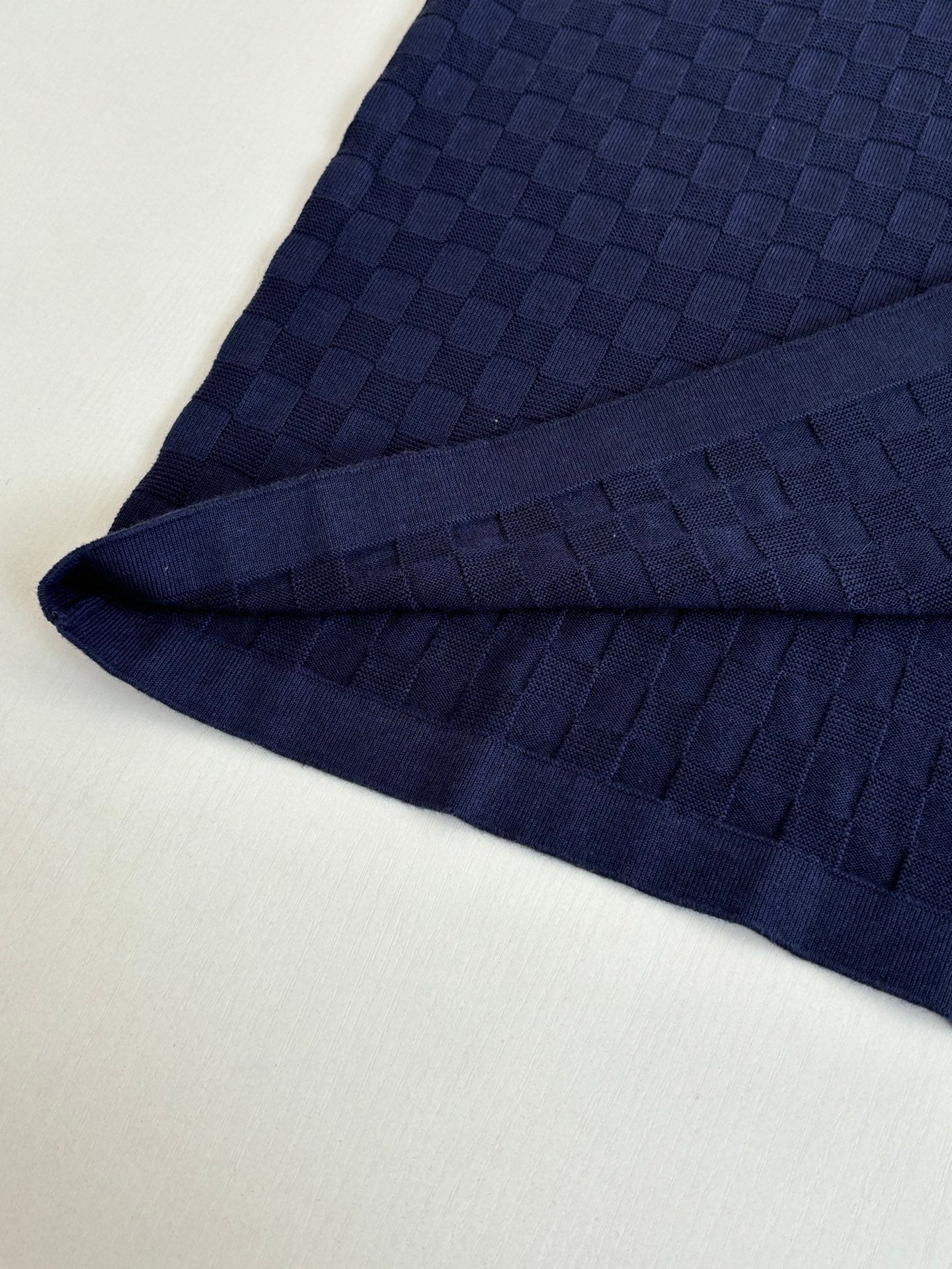 Louis Vuitton dark navy polo shirt fabric detail along sleeve seam