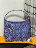 Blue patterned tote bag with top handles and small side pocket detail.