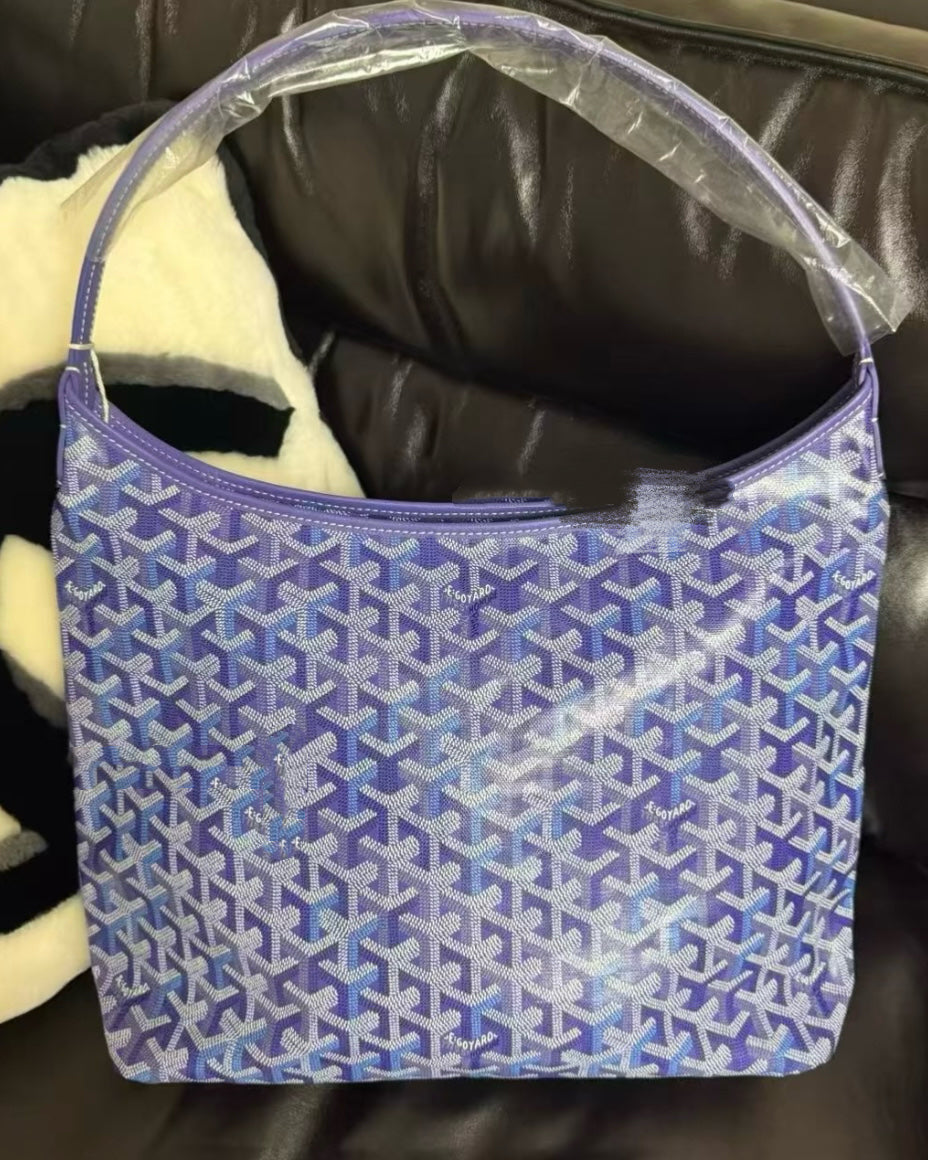 Blue patterned hobo bag with open top and short shoulder handles.