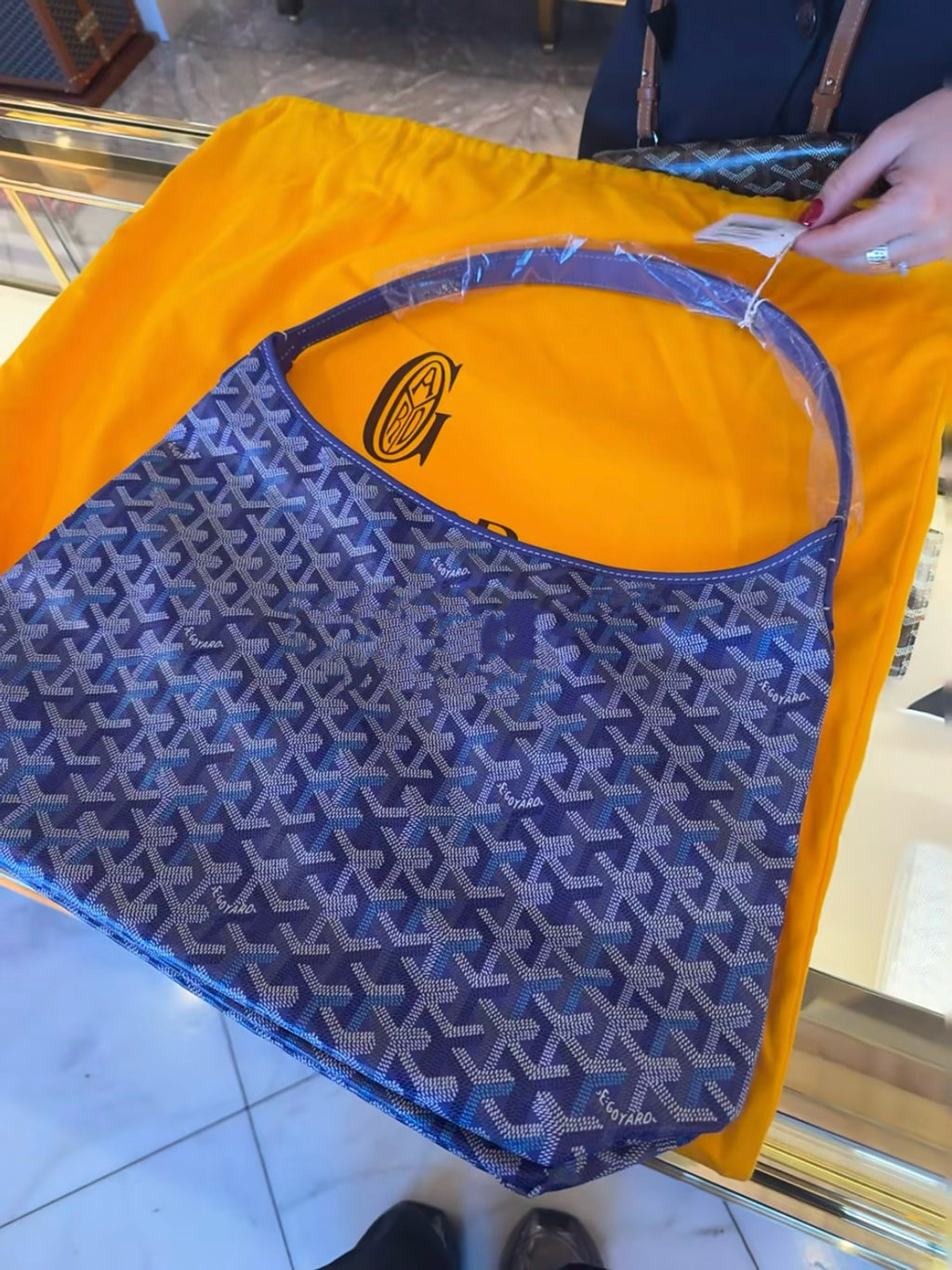 Blue patterned bag with wide open top and visible orange interior lining.