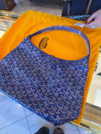 Blue patterned bag with wide open top and visible orange interior lining.