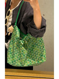 Green lattice-print shoulder bag with top handles and open top