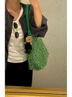 Green lattice-print tote bag with strap and teddy charm at the front