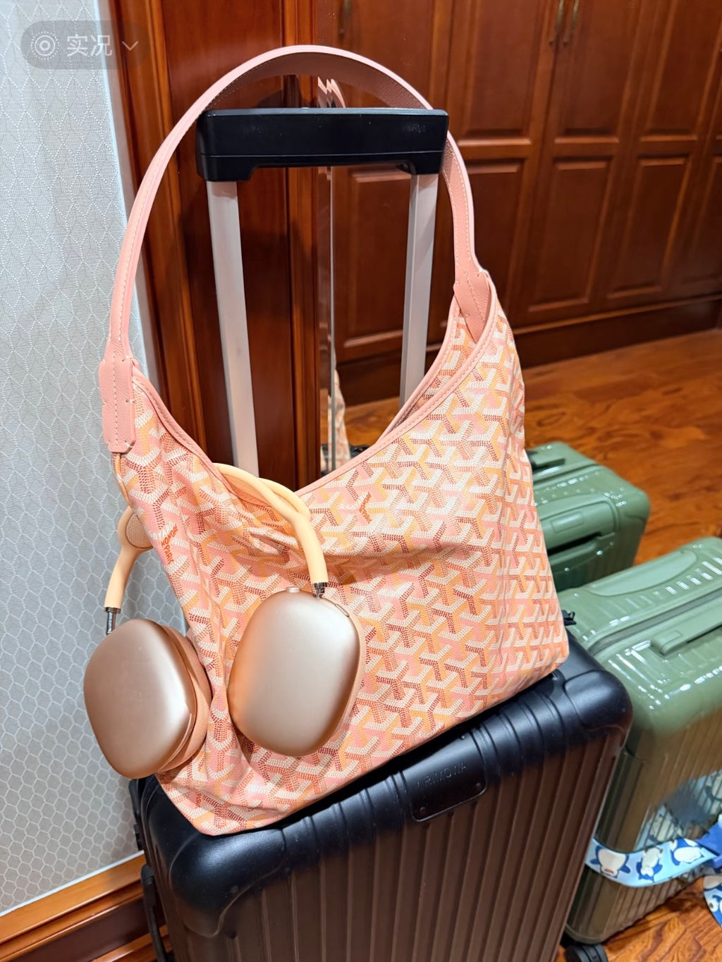 Pink patterned shoulder bag with wide handles and hanging plush accessories