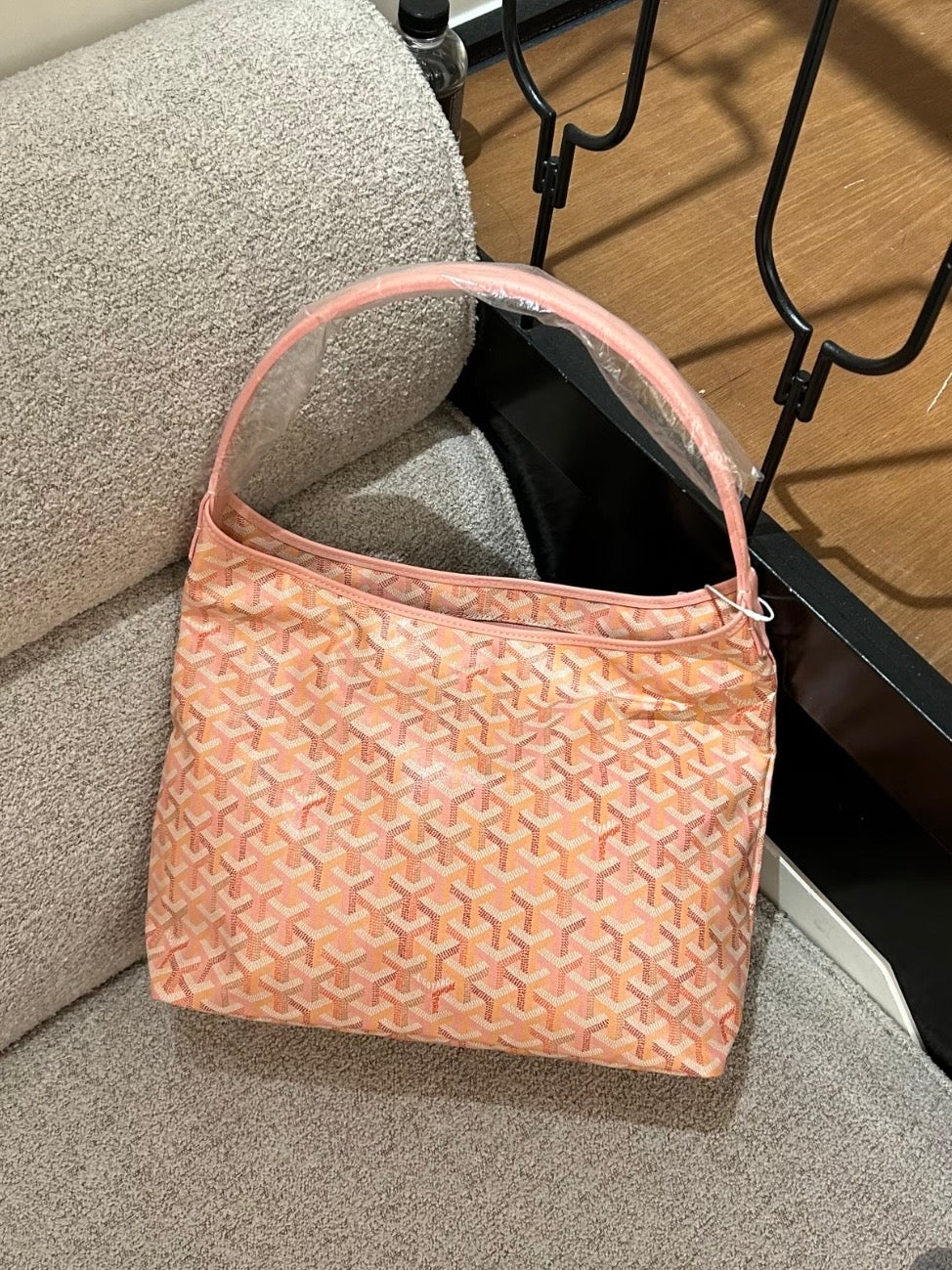 Pink patterned hobo bag with open top and drawstring tie detail