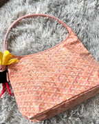 Light pink patterned handbag with open top and short side straps