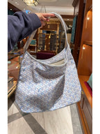 Goyard shoulder handbag in light blue with white pattern, open top, curved handles.
