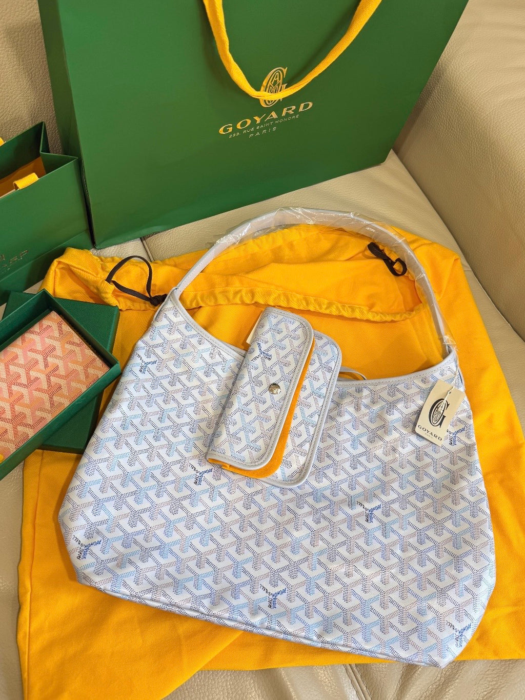 Goyard handbag in light blue with white pattern, matching pouch on strap.