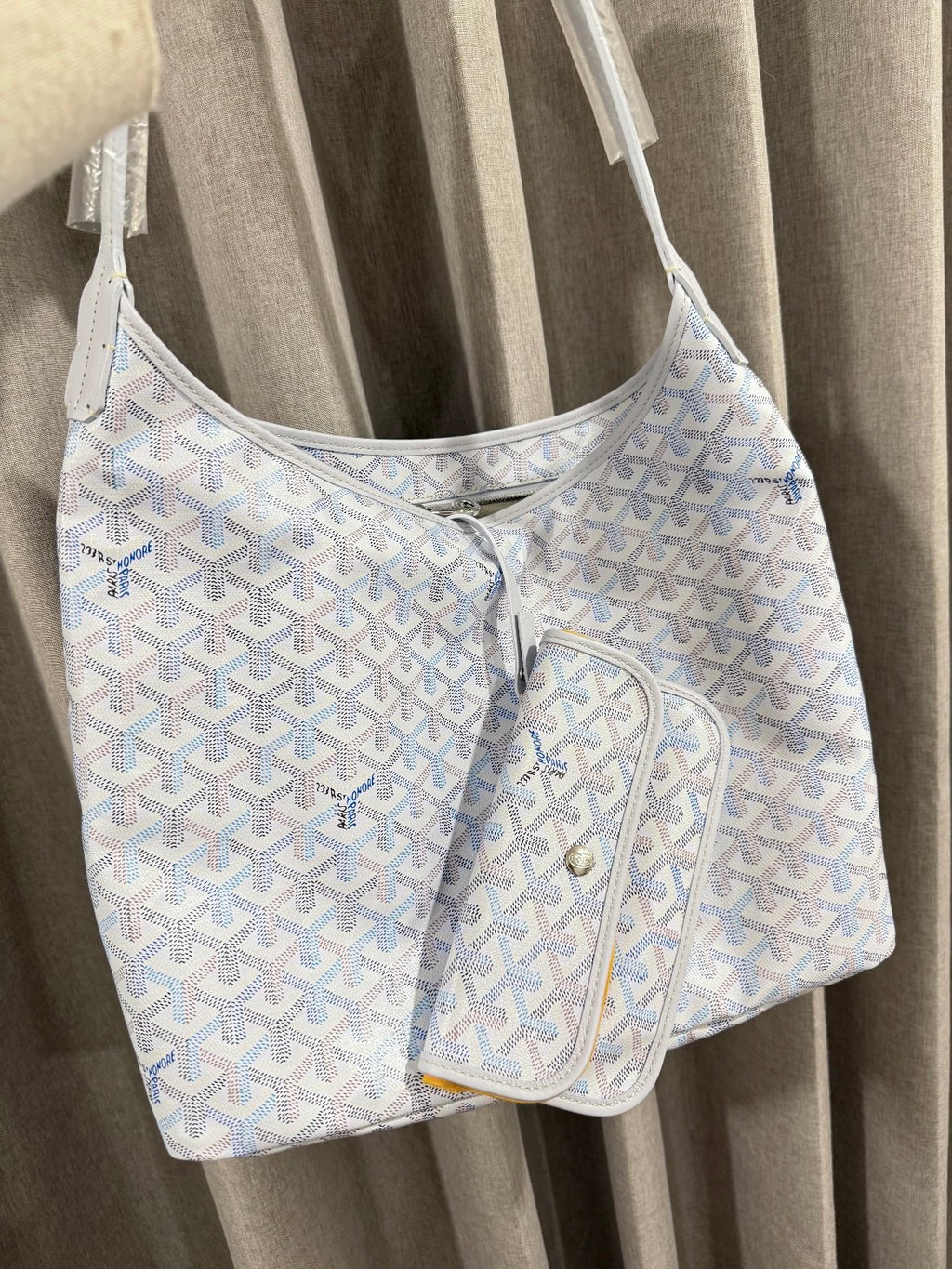 Goyard handbag in light blue with white pattern and attached zip pouch.