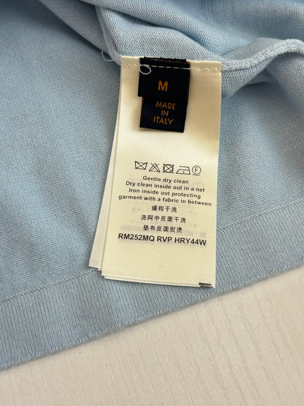 Light blue polo shirt neckline care label and size tag inside
