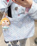 Light blue patterned hobo tote bag with top zipper and short handles