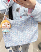 Light blue patterned hobo tote bag with top zipper and short handles