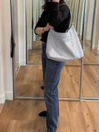 Light blue patterned tote bag with short handles and zip-top closure