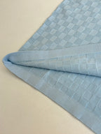 Light blue polo shirt sleeve cuff with textured checker-knit detail