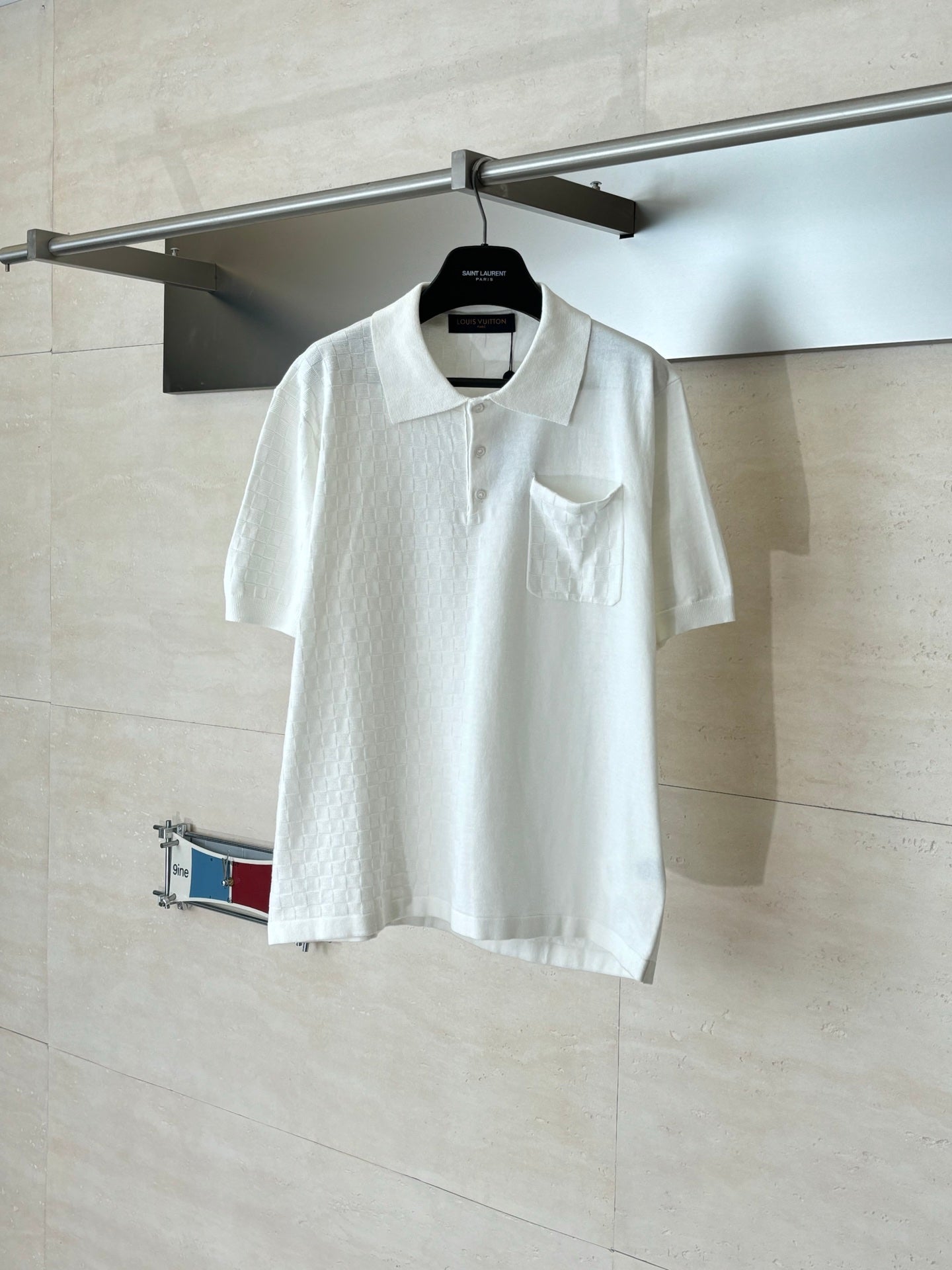 White polo shirt with collar and chest pocket, short sleeves