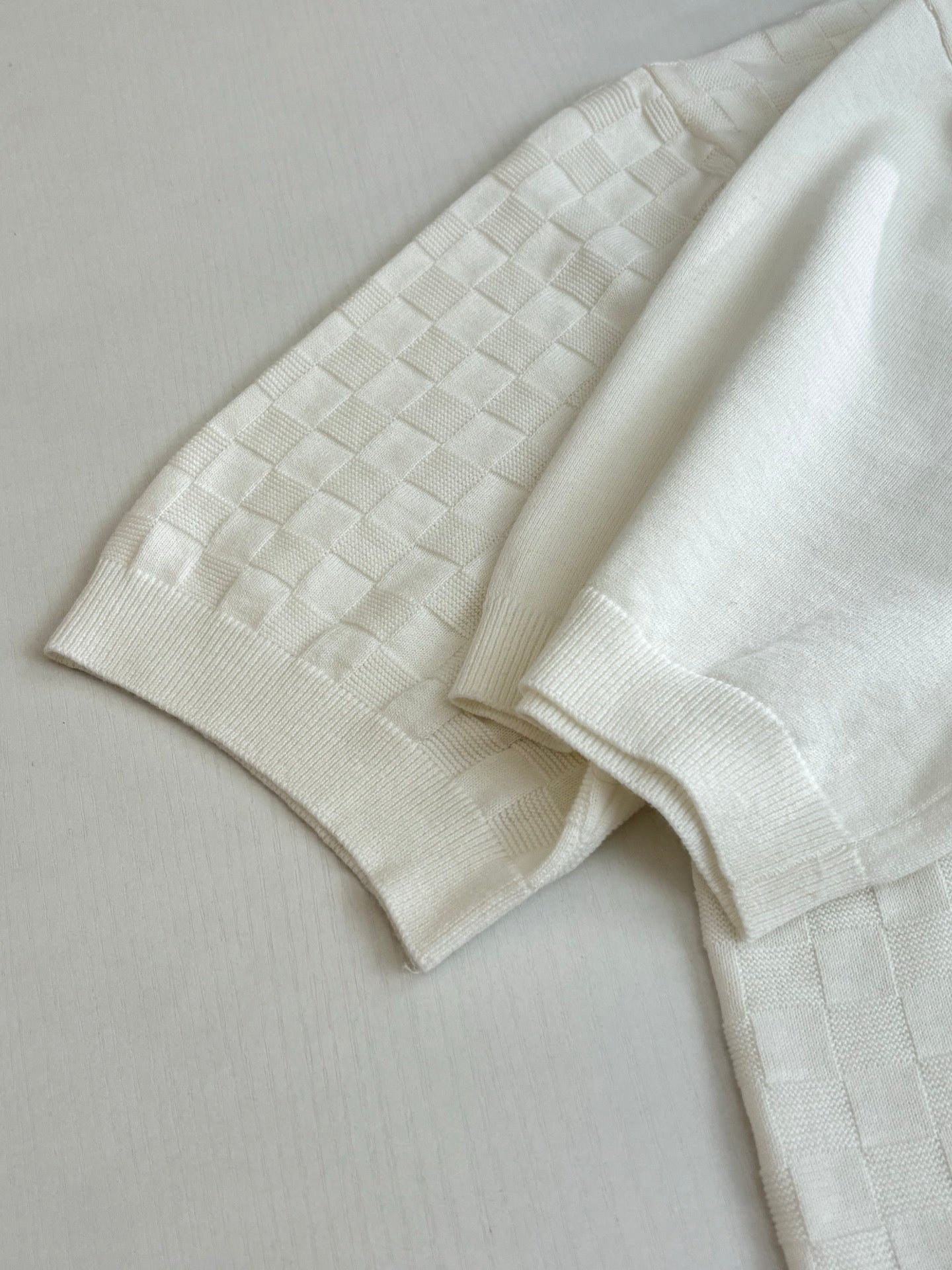 White polo sleeve and placket with textured checker fabric
