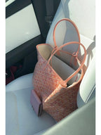 Pink patterned tote bag with top handles and inner lining, side view.