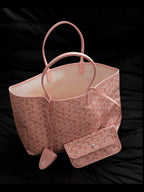 Pink patterned tote bag with top handles, inner lining visible, small key pouch attached.