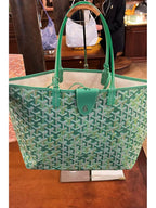 Green patterned tote bag with top handles and small front emblem